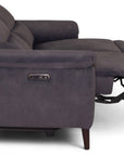 A dark gray reclining loveseat sofa shown from the side with the footrest extended, photographed on a clean white background.