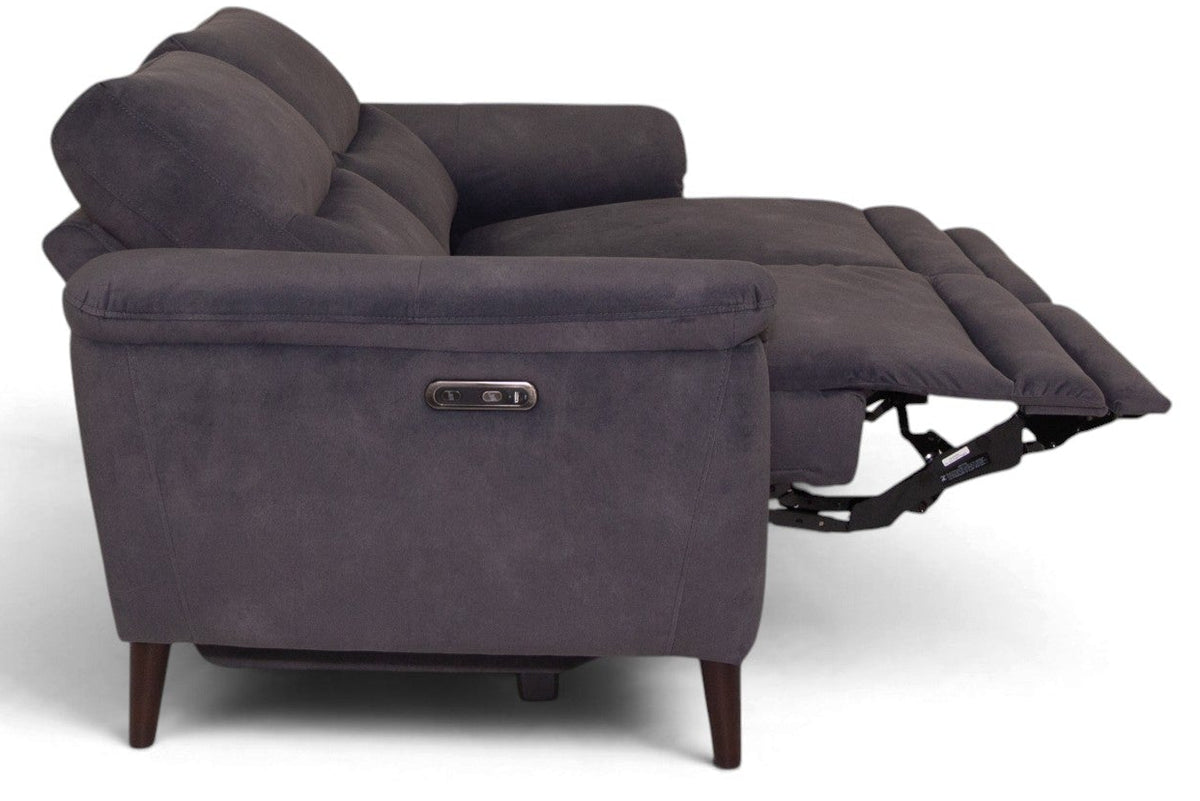 A dark gray reclining loveseat sofa shown from the side with the footrest extended, photographed on a clean white background.